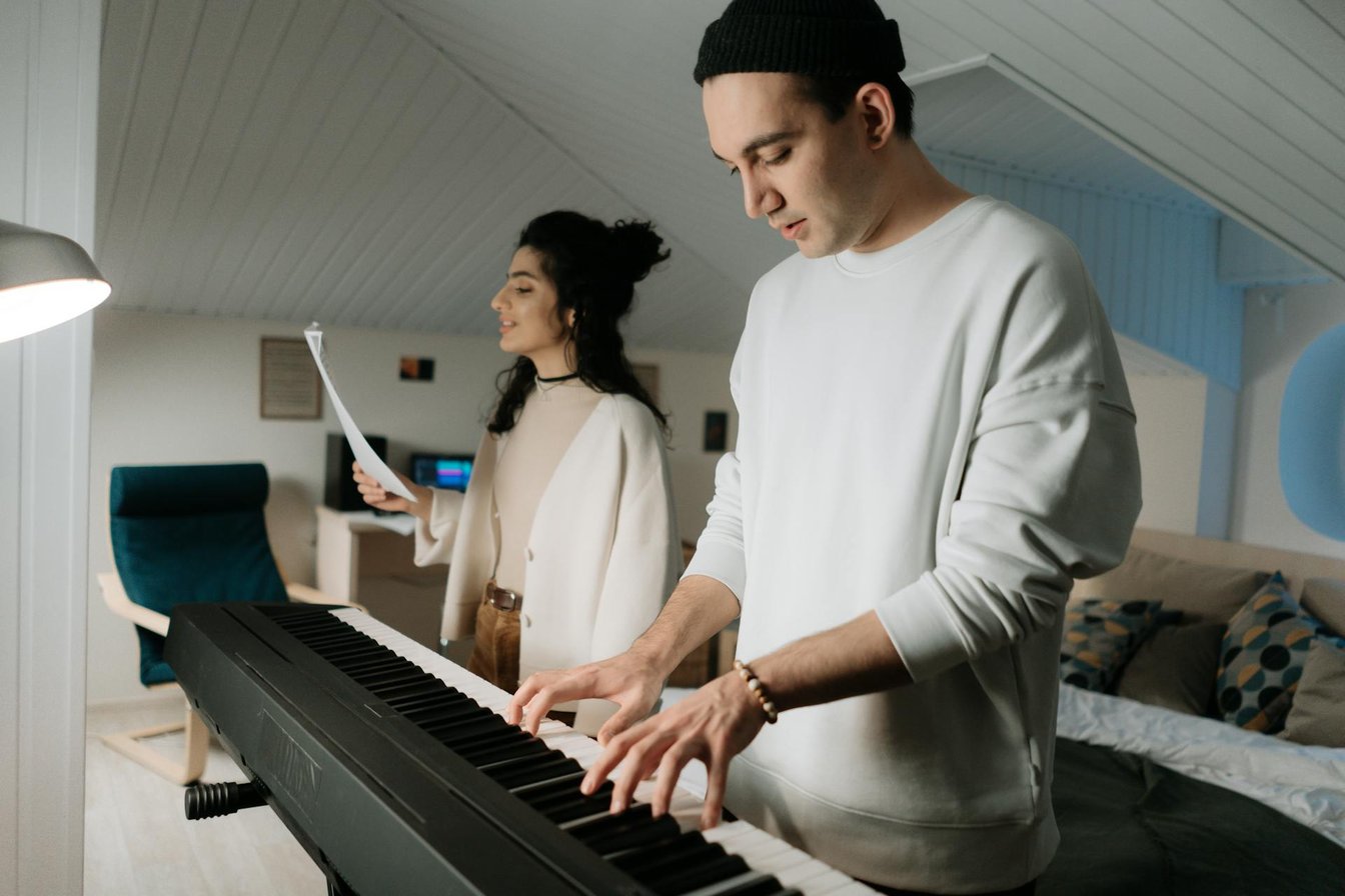 Adult students playing keyboard and singing together